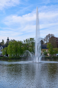 Altenburg / Germany: View from the eastern shore over the Big Pond with the high towering fountain to the historic St. Nicholas steeple in the back