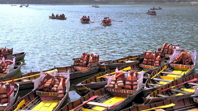 Rowing boats with life jackets docked at Naini Lake shore in Nainital, India