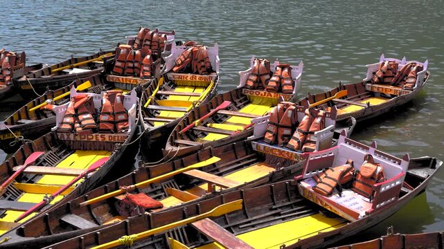 High-angle view of colorful rowing boats docked and moving at Naini Lake, Nainital
