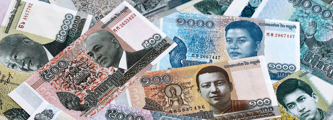 Cambodian riel money banknotes pile on table. Cambodia bills of KHR currency close up © Larysa