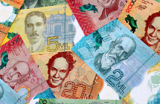 Costa Rican new colon money banknotes pile on table. Costa Rica bills of CRC currency close up