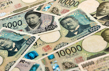 Japanese yen money banknotes pile on table. Japan bills of JPY currency. Concept of economy © Larysa