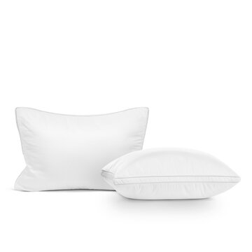 Set of two white soft bed pillows isolated on white background.