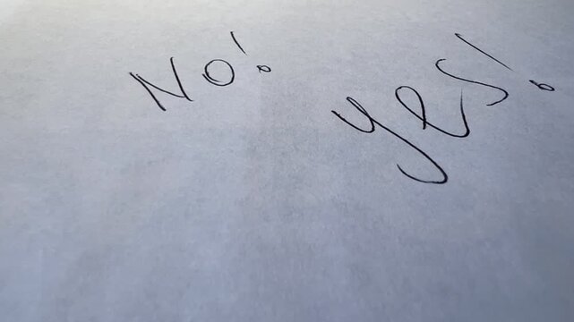 writing no and yes on paper