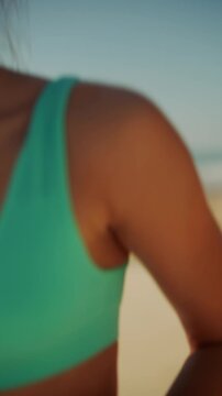 Beach fitness session showing focused woman with windtousled hair