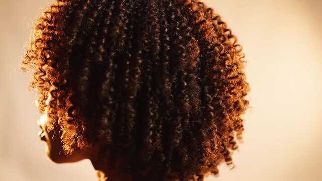 Natural 4C coily hair curls bouncing in slow motion with shine, inclusive beauty hair care celebration video