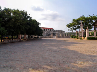 Naklejka premium Plaza de Armas in Old Havana Cuba with historical colonial architecture alongside Castillo de la Real Fuerza