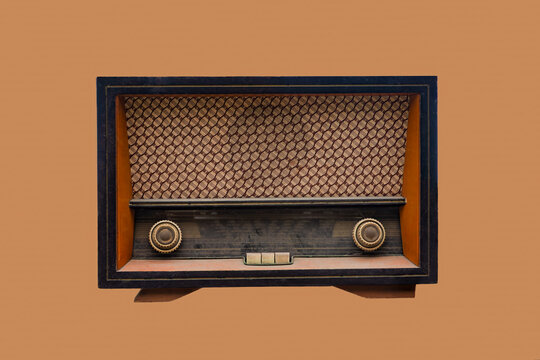 Antique Tabletop Tube Radio with Wooden Cabinet and Woven Grille plain brown background.