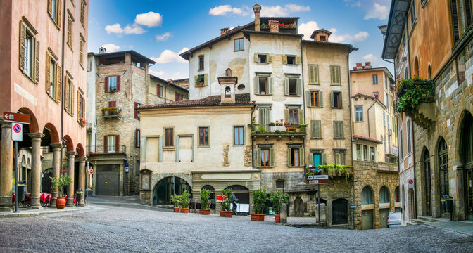 Historic Piazza Mercato delle Scarpe in Bergamo Citt&agrave; Alta surrounded by medieval stone buildings