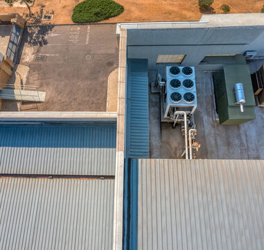 Nadir aerial view of industrial building rooftop with HVAC unit and corrugated metal roofing