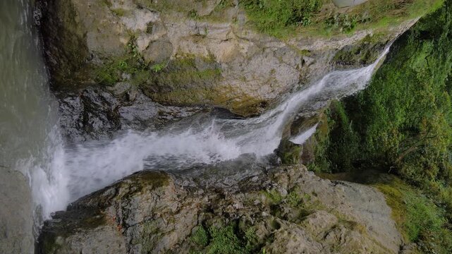 Vertical video: Andrew the Apostle waterfall in the mountain - river or stream of water is flowing and falling down. Nature, landscape and environment concept