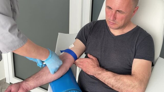Nurse in blue latex gloves collecting blood sample from patient vein during clinical laboratory testing procedure sterile healthcare practices, routine clinical examination in medical environment. 