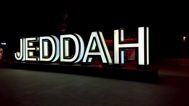 Illuminated Jeddah sign landmark at night on the waterfront, Saudi Arabia