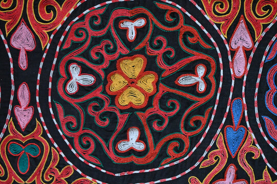 Close-up traditional Mongolian embroidery pattern red waves.