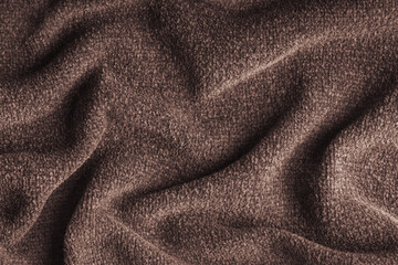 Closeup, macro of brown microfiber fabric texture with soft folds and drapery. Plush, fleece textile surface suitable for background, wallpaper and design use. Upholstery, decorative cloth © katyamaximenko