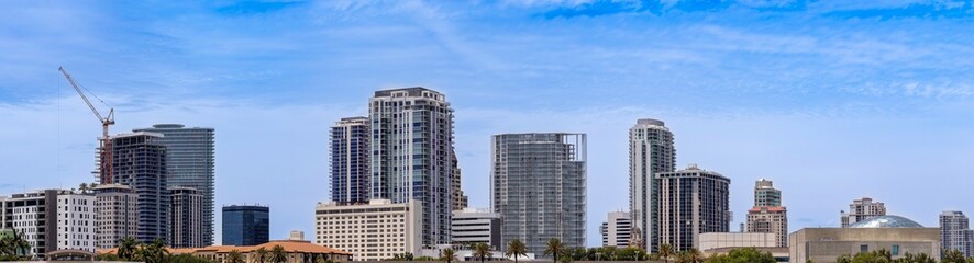 Panoramic skyline view of downtown St. Petersburg modern skyscrapers, residential high-rises and construction cranes against a blue sky, Florida, USA © Andrei Liashchou