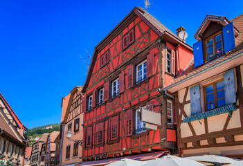 Obraz premium Ornate half timbered houses, flowers in Ribeauville, France, Alsatian Wine Route