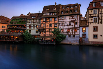 Obraz premium Half timbered houses by canals of Petite France in Strasbourg, France at sunset
