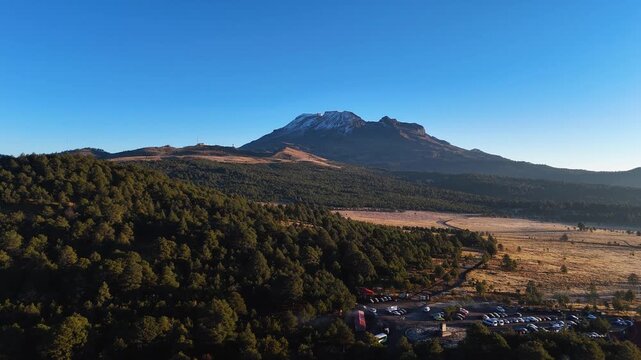 Panoramic Aerial View of Iztaccihuatl Volcano and High-Altitude Pine Valley, 4K 60ps horizontal slanted ascend drone shot of Iztaccihuatl, Mexico in a clear day