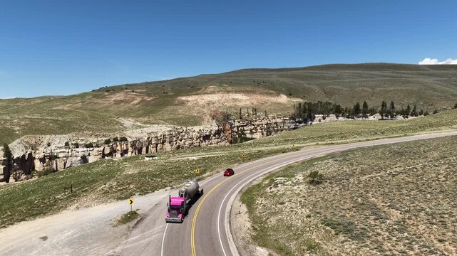Aerial of semi truck on mountain pass north of Vernal Utah in spring on sunny day