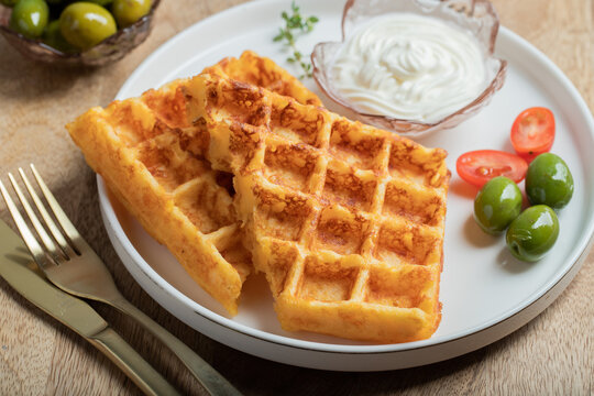 Crunchy waffle fries with sour cream dip served in a basket