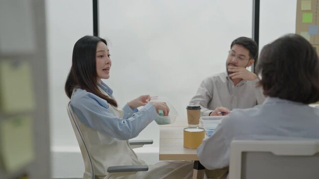 Business meeting in modern office conference room with three colleagues discussing project over coffee, teamwork, and professional planning for office discussion