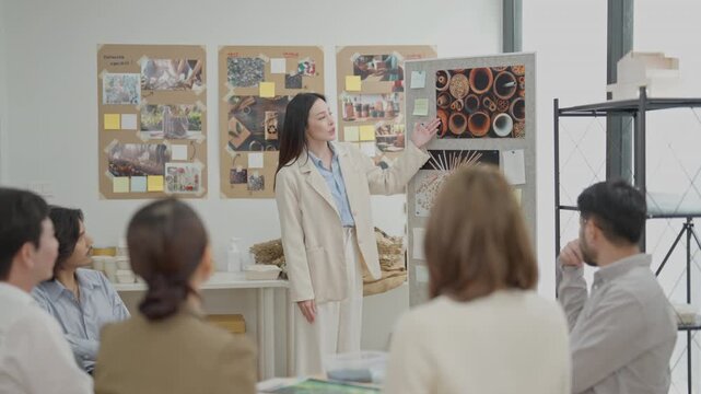Workshop presentation with team meeting creative office, woman speaking beside mood board and design board, business meeting woman presentation team office discussion boardroom project collaboration
