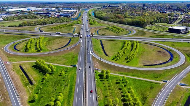 Aerial drone view road junction. Clover roundabout view from above. Car traffic on autobahn Netherlands. . High quality 4k footage