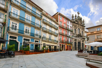 Obraz premium The colorfully tiled Largo de São Domingos square with the baroque Igreja da Misericórdia church in view in the historic Ribeira district of Porto, Portugal.