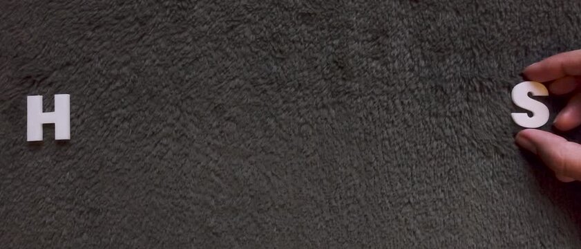 the word hantavirus written with white capital letters in a gray textured background (slow version)