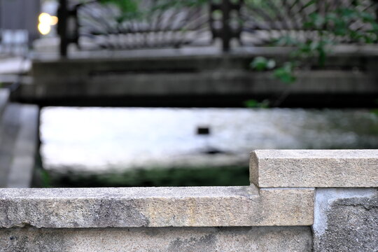 Scenery of a bridge wrapped in vibrant fresh green maple leaves and natural light of early summer in Kyoto