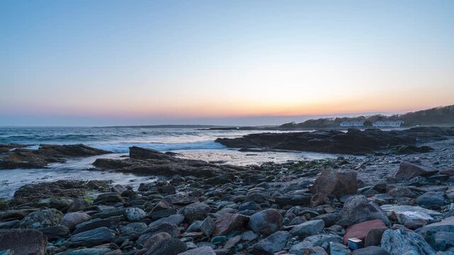 Newport rocky coast sunset timelapse, capturing moving clouds and twilight colors fading over a rugged stone beach and crashing waves in Newport, Rhode Island.