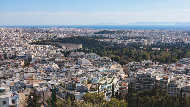 Athens, Attica, Greece, beautiful panoramic view of Athens cityscape, with The Parthenon, mountains, sea and scenery beyond the city, seen from Mount Lycabettus Hill observation deck in a sunny day