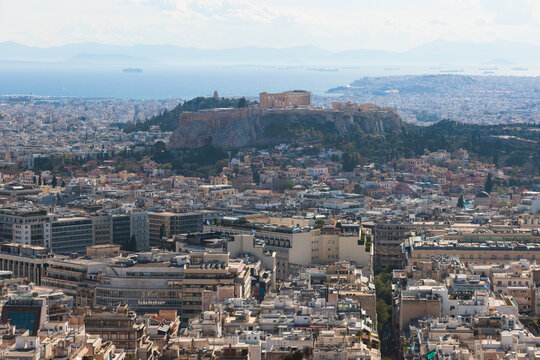 Athens, Attica, Greece, beautiful panoramic view of Athens cityscape, with The Parthenon, mountains, sea and scenery beyond the city, seen from Mount Lycabettus Hill observation deck in a sunny day