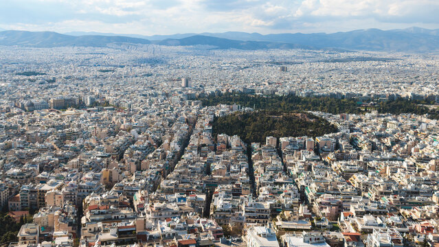 Athens, Attica, Greece, beautiful panoramic view of Athens cityscape, with The Parthenon, mountains, sea and scenery beyond the city, seen from Mount Lycabettus Hill observation deck in a sunny day