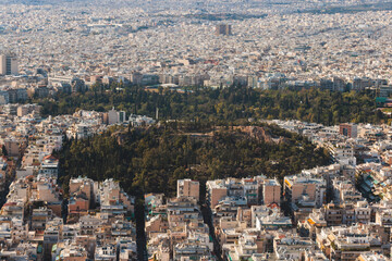 Fototapeta premium Athens, Attica, Greece, beautiful panoramic view of Athens cityscape, with The Parthenon, mountains, sea and scenery beyond the city, seen from Mount Lycabettus Hill observation deck in a sunny day
