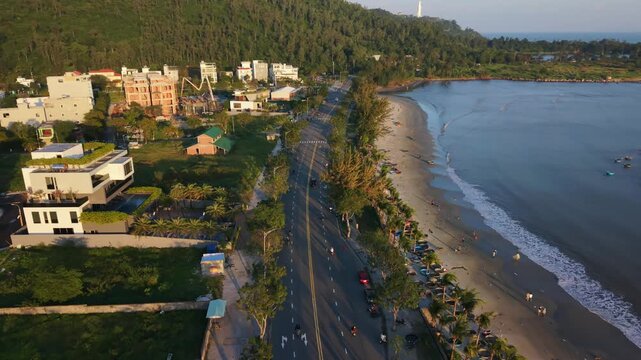 Vietnam, Da Nang Aerial Da Nang Beachfront Road Evening, Lowrise Hotels And Villas Lining Shoreline, Gentle Waves Meeting Sand, Motorcycles And Cars Traveling Along Palmfringed Highway,