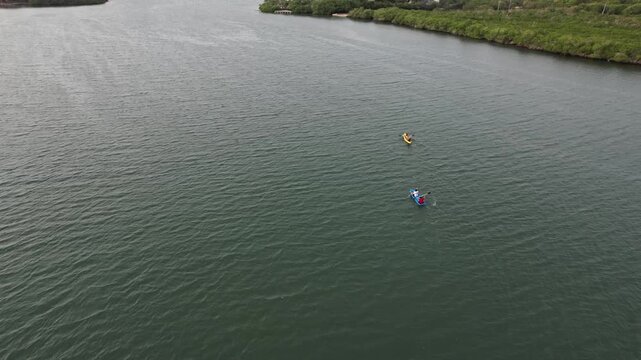 Aerial view of two kayakers paddling on a river