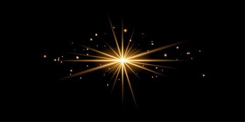 Obraz premium Golden Starburst Light Effect with Floating Particles on Black Background glow sparkle