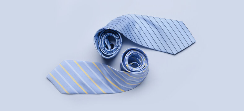 Stylish neckties on light background