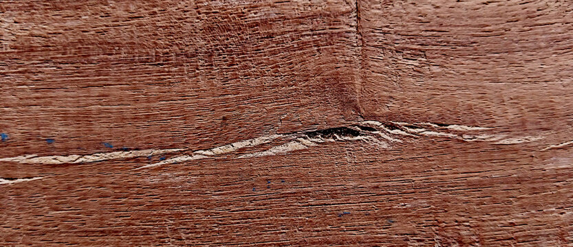 Rustic mahogany wood texture with natural grain, dark reddish brown timber surface background, weathered hardwood plank with organic cracks