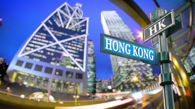 Skyscrapers with traffic car light trail timelapse. Hong Kong of China. Selective focus of travel sign Hong Kong with real timelapse background from raw photo sequence. Beautiful vibrant city vibe.
