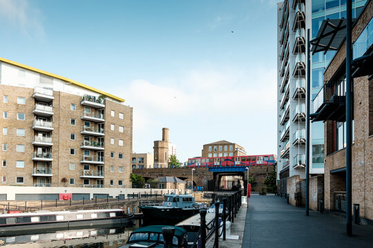 London canal with apartment buildings and dlr train passing