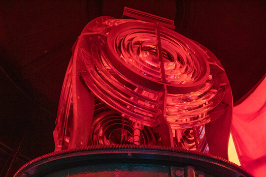 Red lighthouse beacon lens close-up at night