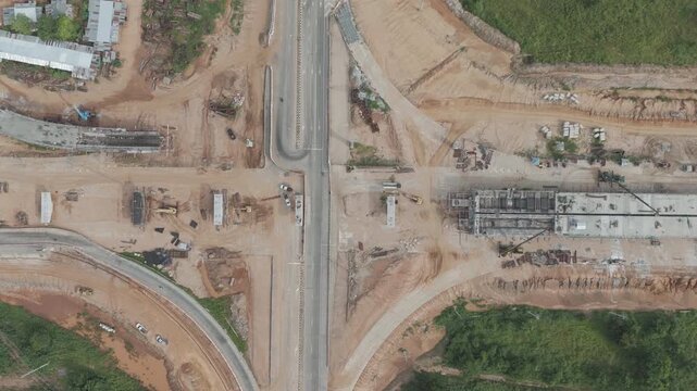 Aerial view drone footage of construction site building cross intersection bridge
