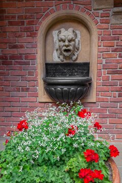 Fountain with mascaron in the courtyard of Collegium Maius in Krakow, Poland