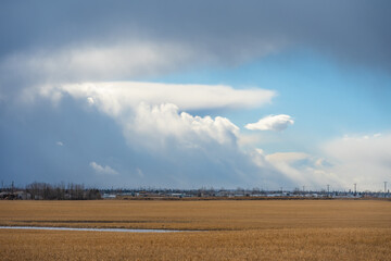 Fototapeta premium Farm field with storm clouds in the sky