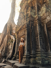Fototapeta premium Luxury Cambodia Travel Experience Woman at Ta Prohm Temple