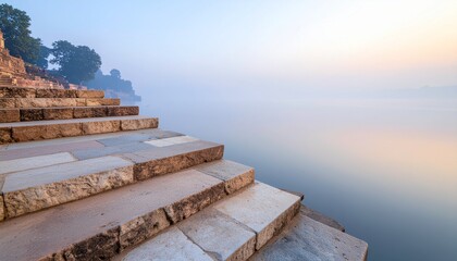 Fototapeta premium Ancient Stone Ghat Steps Leading into the Calm Waters of the Ganges River at Sunrise in Varanasi