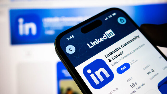 Closeup of a smartphone screen displaying the linkedin app store page, showing the professional networking platforms logo and download button